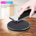 Black circular Qi wireless charging pad for iPhone 11 with non-slip surface
