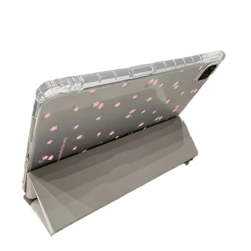 Transparent floral patterned tri-fold protective case for Apple iPad in stand position.