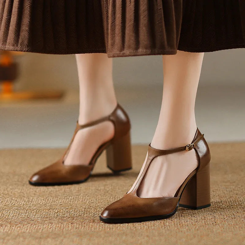 Women's retro pointed toe Mary Jane heels in dark brown with a buckle strap and hollow front design.