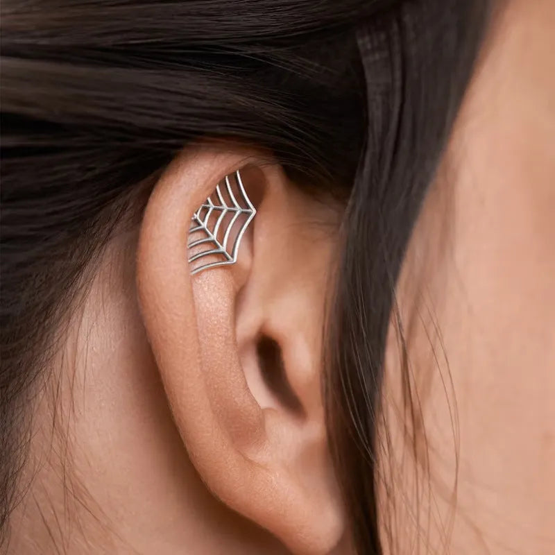 Geometric spider web design metal stud earrings in a gold electroplated finish.