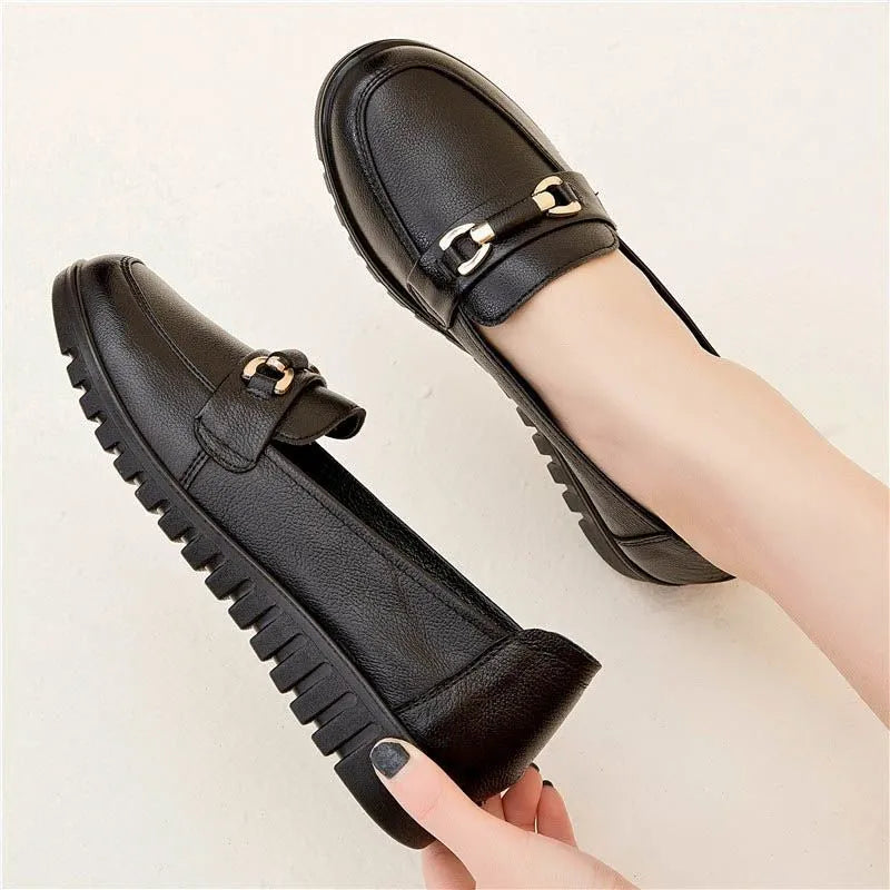 Black women's soft leather casual pumps with a low flat heel and round toe.
