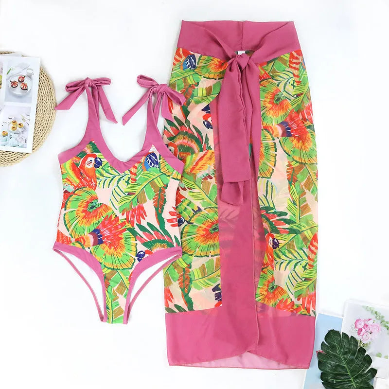 Retro pink floral print women's one-piece swimsuit with a V-neck, covered belly, and thin skirt.