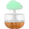 White raining cloud humidifier with essential oil diffuser and multi-colour night light on table