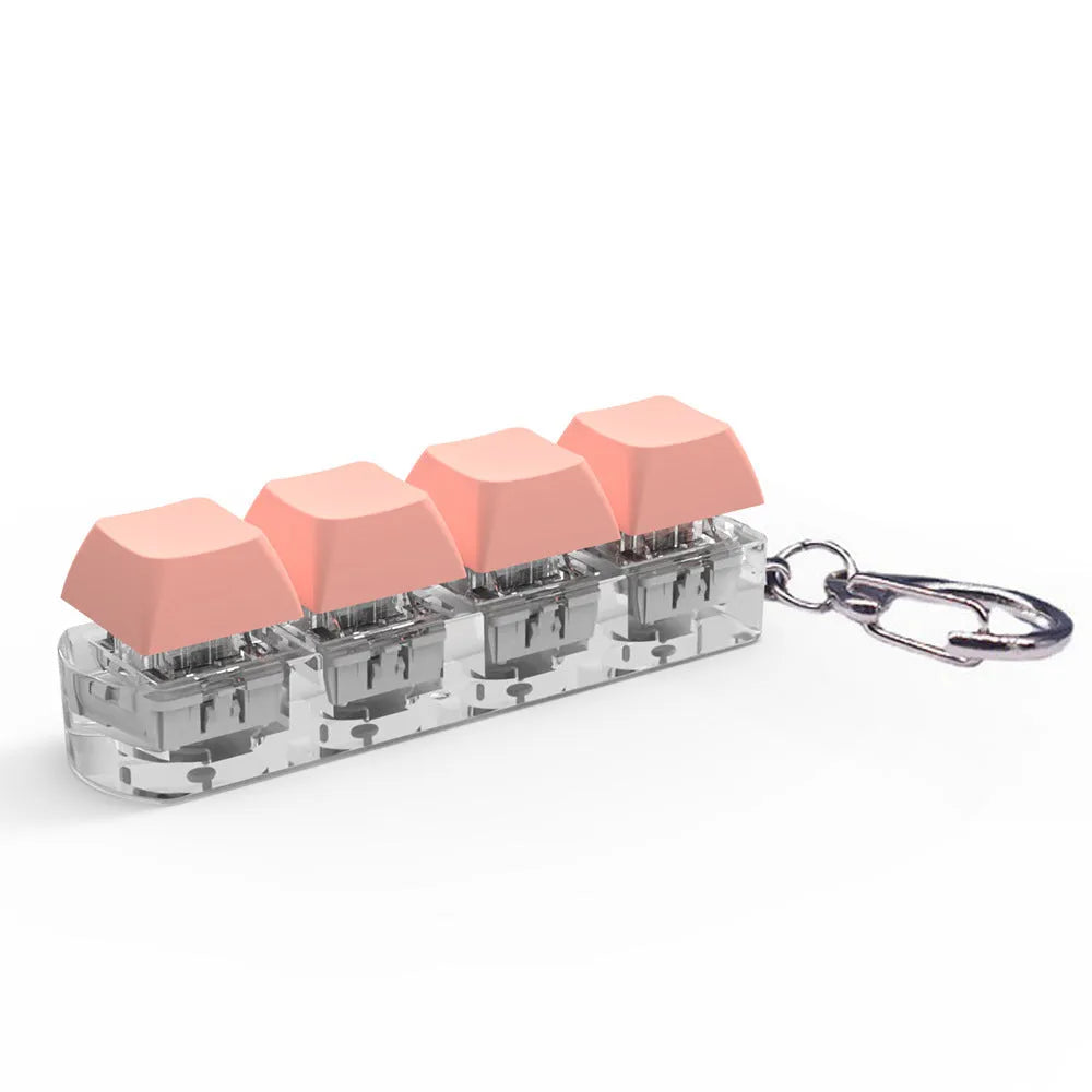 Compact 4-key mechanical keyboard switch tester on a desk, showing coloured ABS plastic construction.