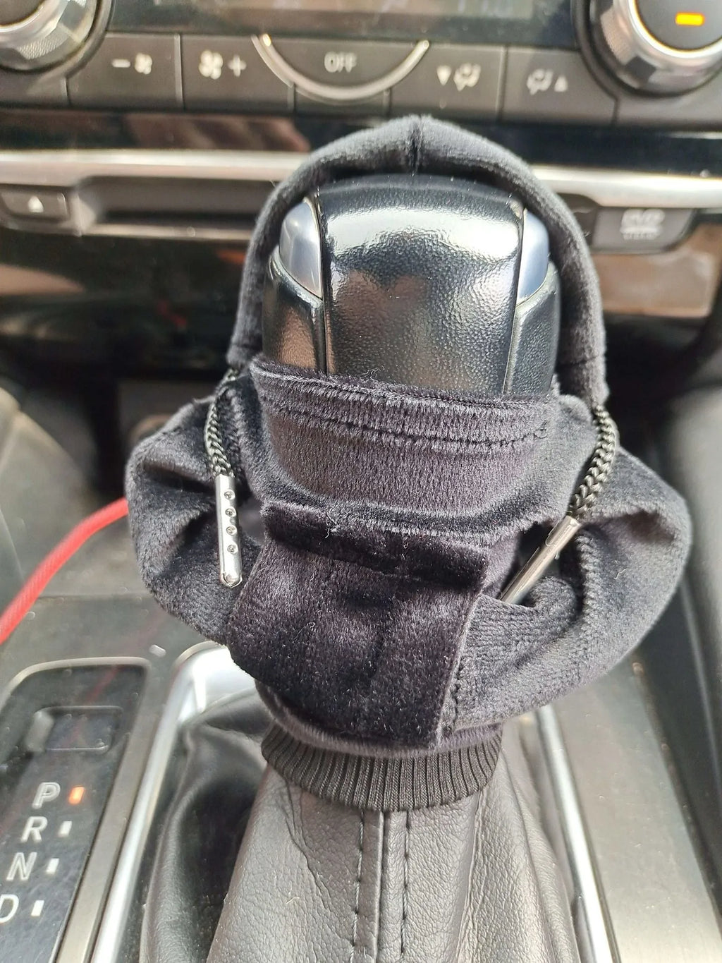 Pure cotton car gear lever sweater decoration in assorted colours on a gear stick.