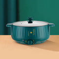 Non stick electric pot in stainless steel with integrated heating element and multiple cooking functions