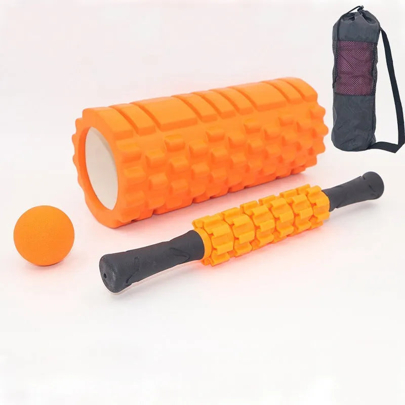 Black handheld foam massage roller bar with six white textured gear pieces on a 33cm shaft.