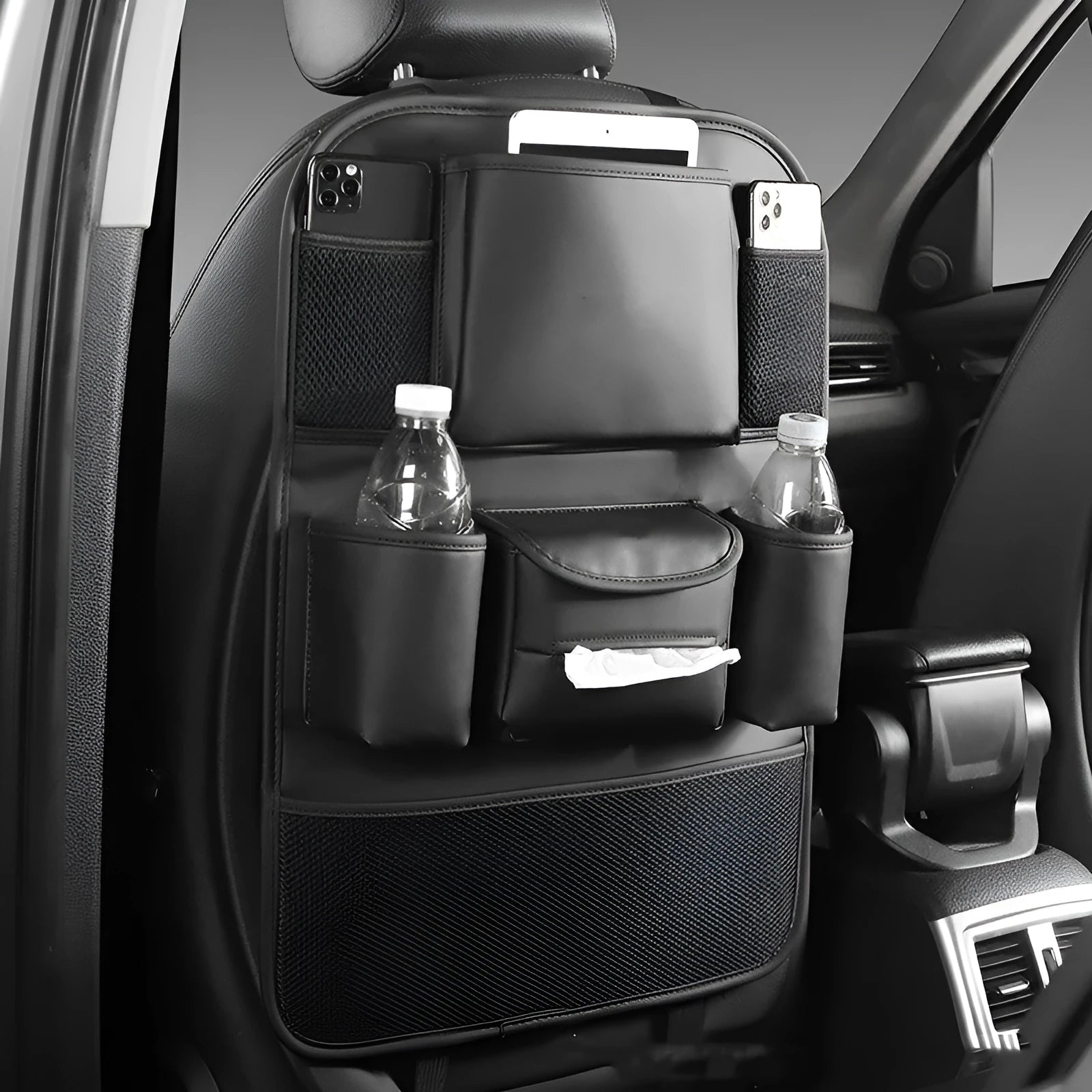 Black leather storage bag hanging on the back of a car seat.