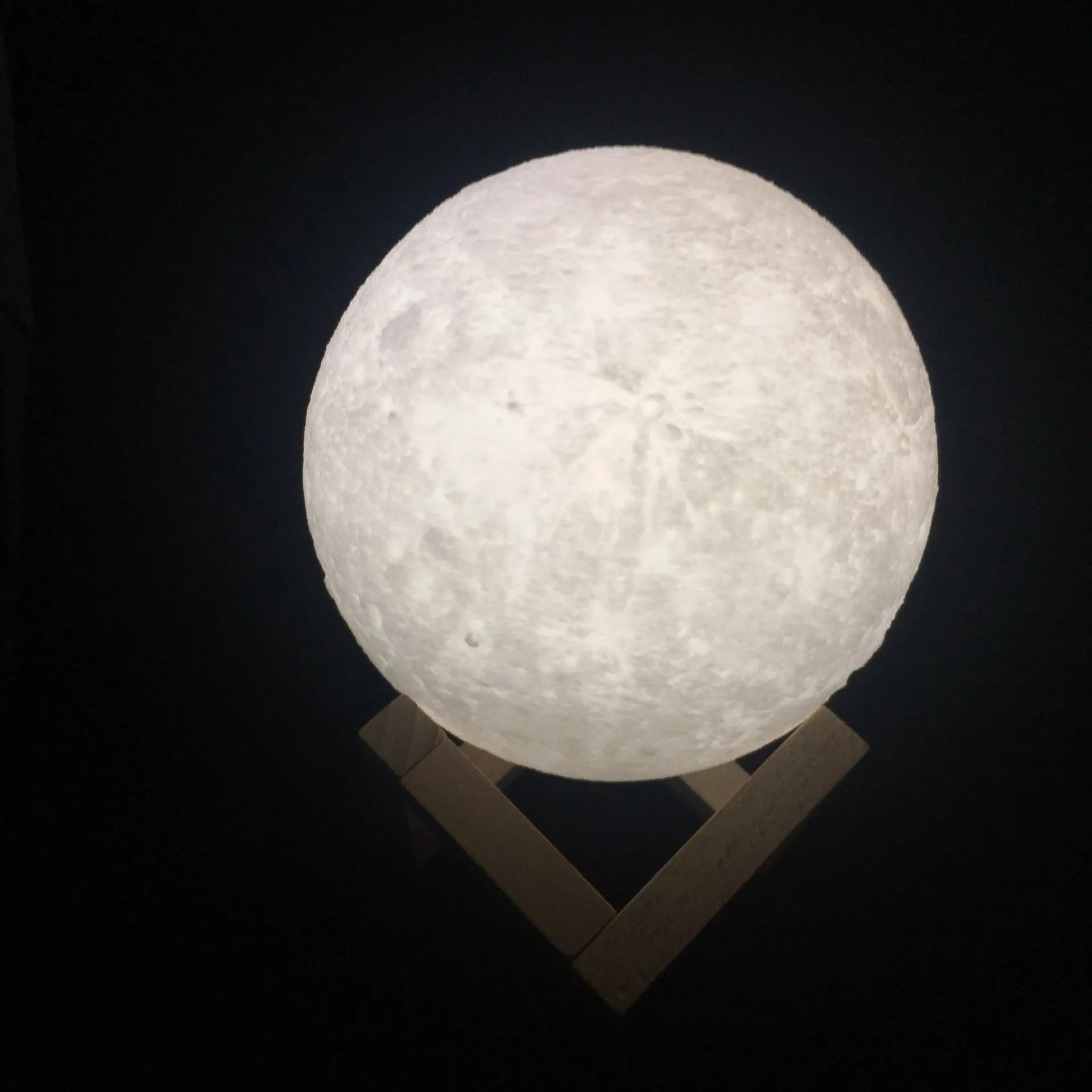 3D-printed white moon lamp on wooden stand with touch-sensitive metal ring base