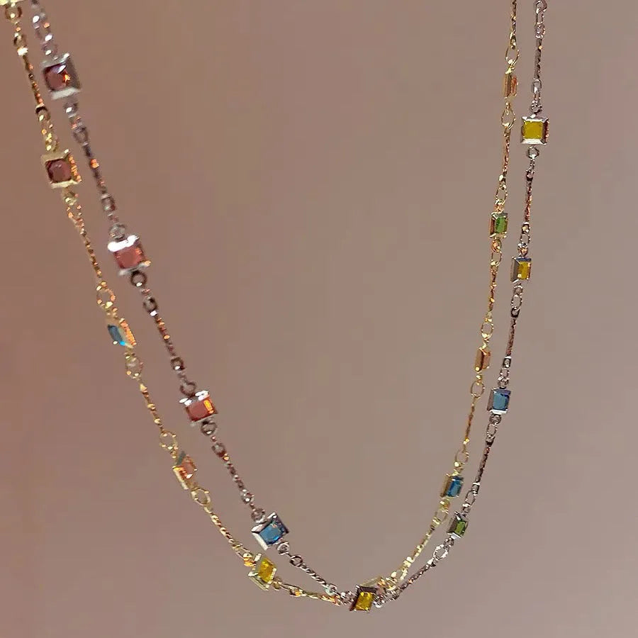 Square geometric artificial crystal pendant on clavicle-length alloy chain necklace in gold tone