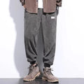 Men's grey straight-leg sweatpants with ankle ties on a hanger