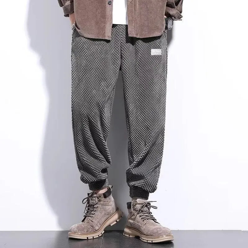 Men's grey straight-leg sweatpants with ankle ties on a hanger