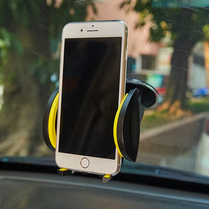 Red ABS suction cup U-shaped mobile phone bracket mounted on car dashboard holding smartphone