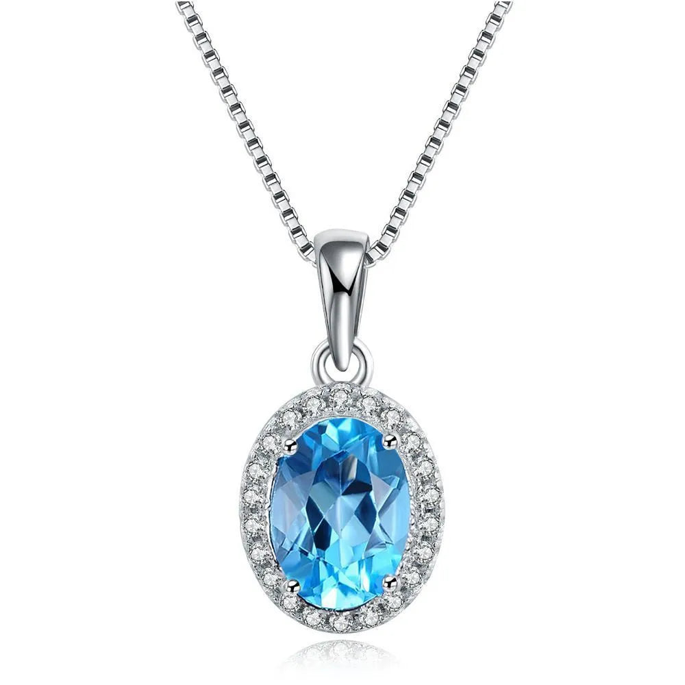 Four-piece sterling silver jewellery set with blue topaz stones including geometric earrings, ring, bracelet and necklace
