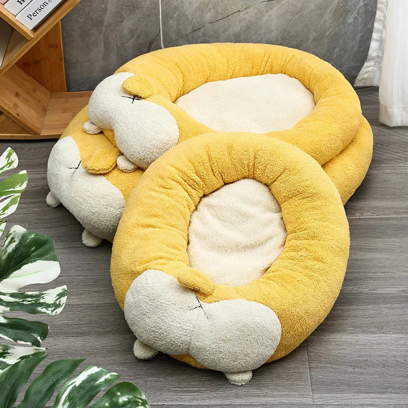 Corgi-shaped plush pet bed for dogs and cats in grey, shown in a home setting.