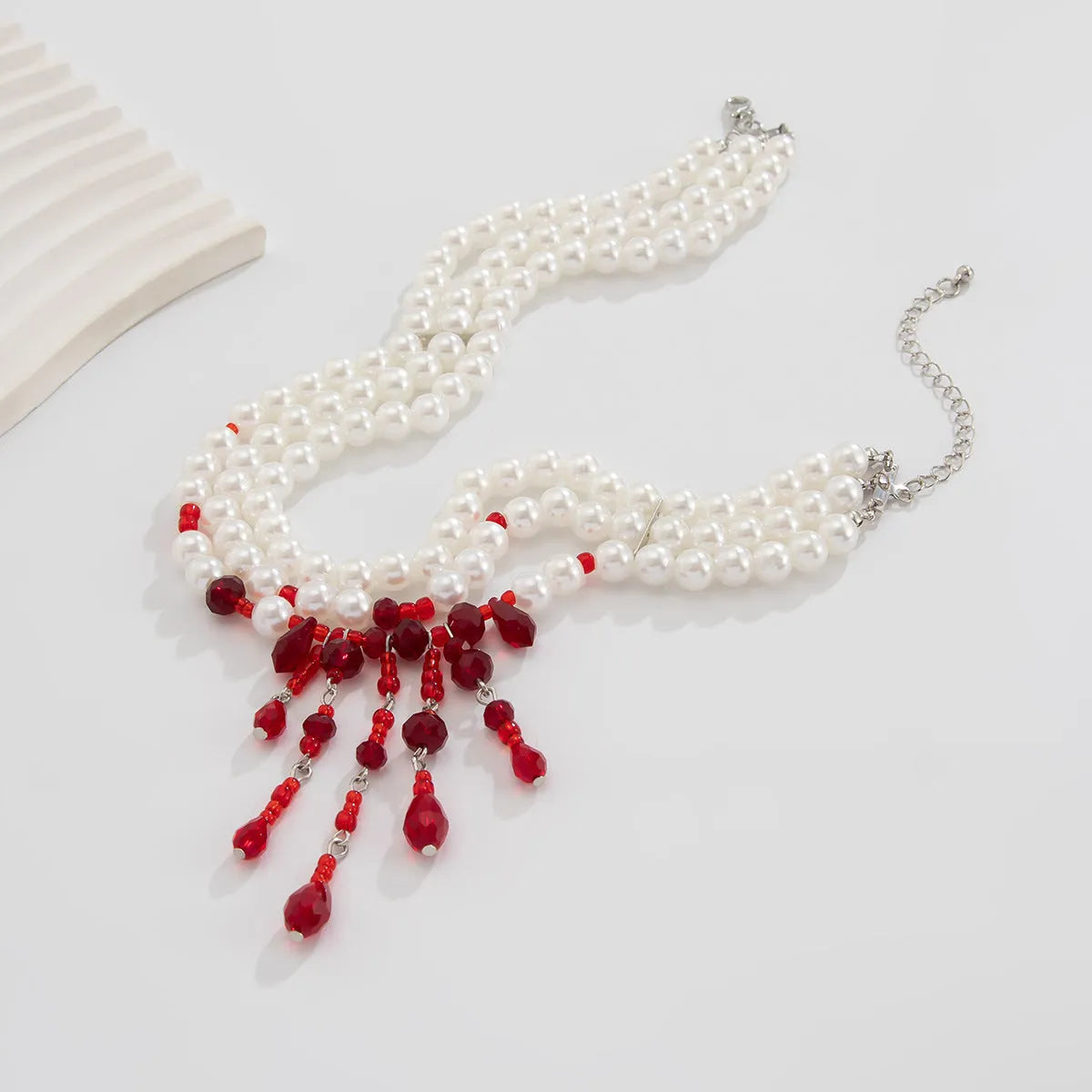 Men's Halloween necklace with red and black crystal blood drop pendant and pearl tassels on an adjustable chain