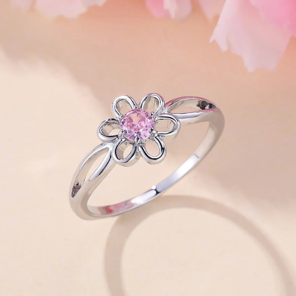 Lady's copper ring with hollowed flower design in platinum pink diamond colour showing size options