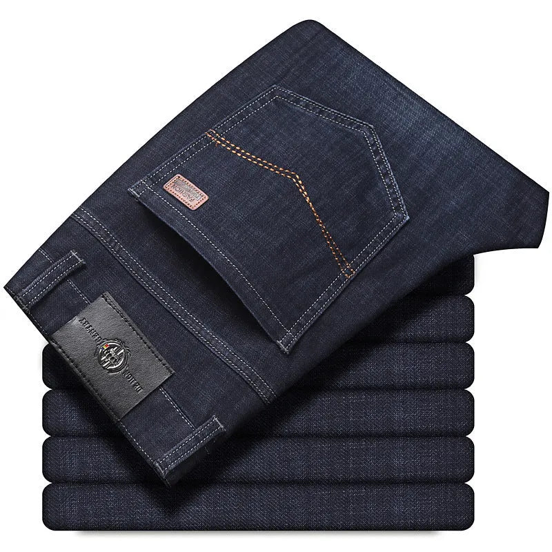 Man wearing loose fit straight-leg stretch jeans in blue denim for a business casual look.