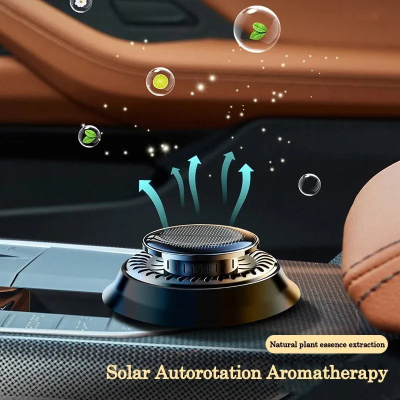 Solar-powered kinetic car air freshener with double-ring rotating mechanism in black plastic housing