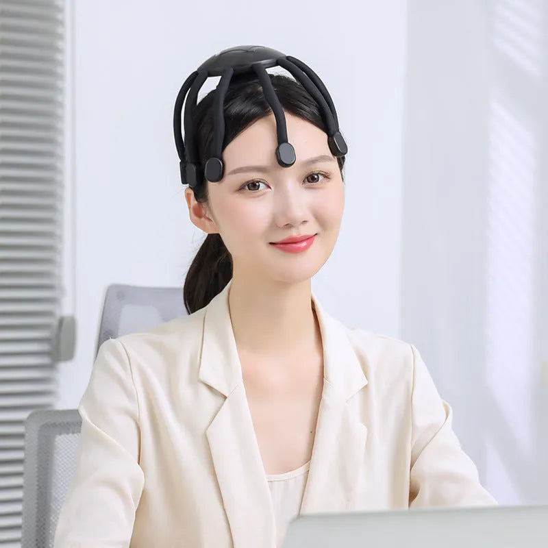 Black handheld USB head massager with multiple vibrating claws for scalp relaxation.