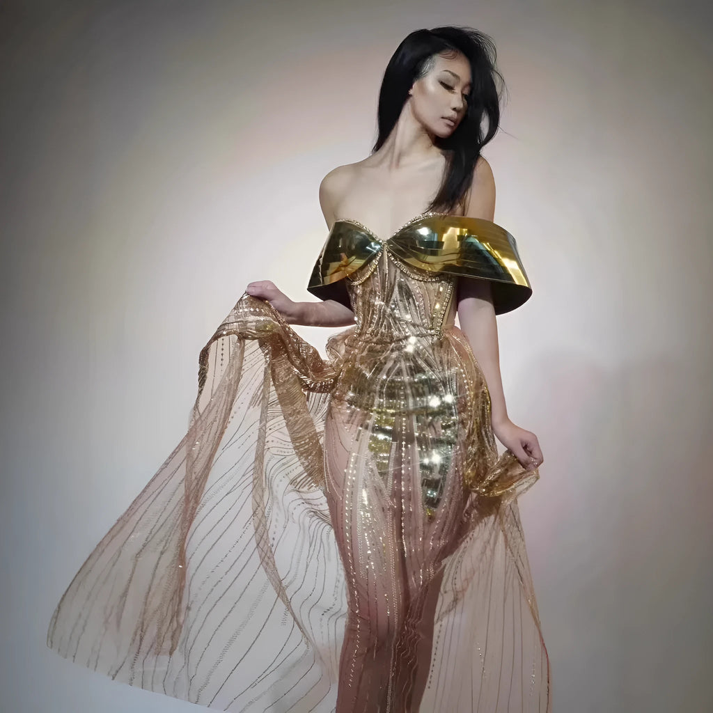Gold strapless sequin evening dress with high-low hemline and tulle skirt detailing.