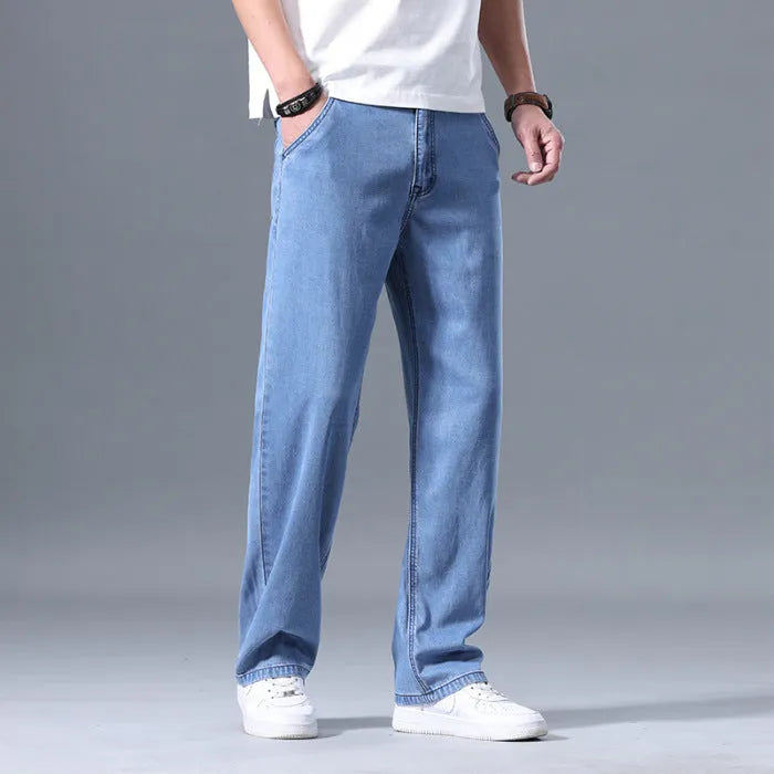 Men's loose straight-leg lyocell jeans in light blue colour showing front view with zipper fly