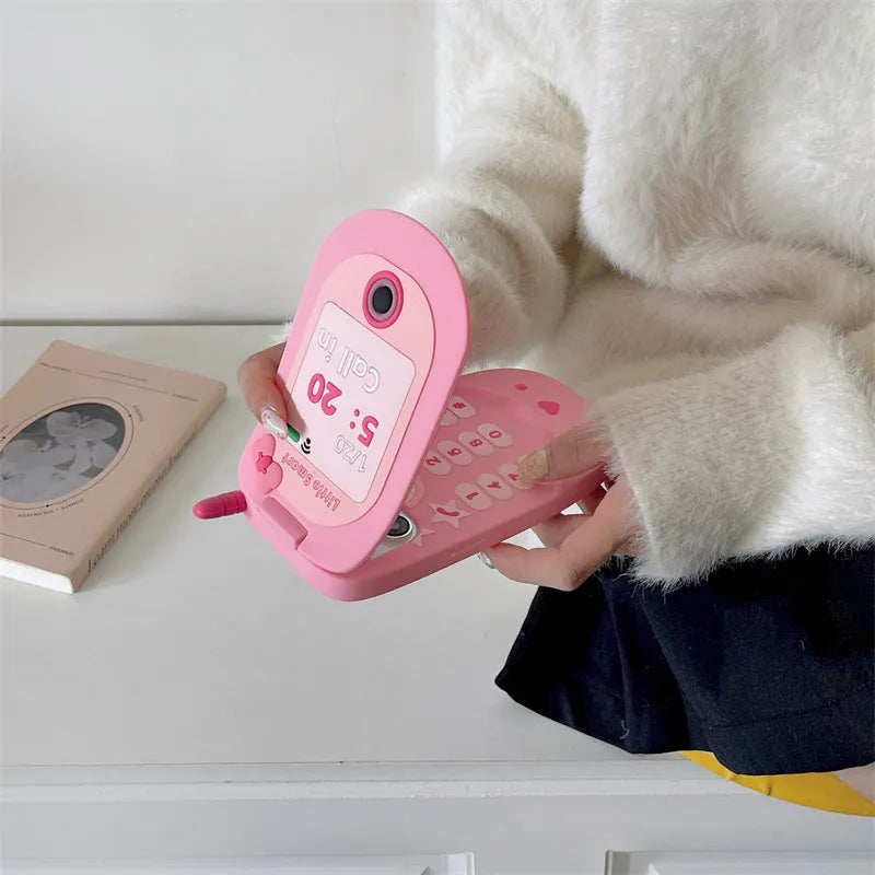 Pink silicone iPhone case shaped like a flip phone with a front mirror.