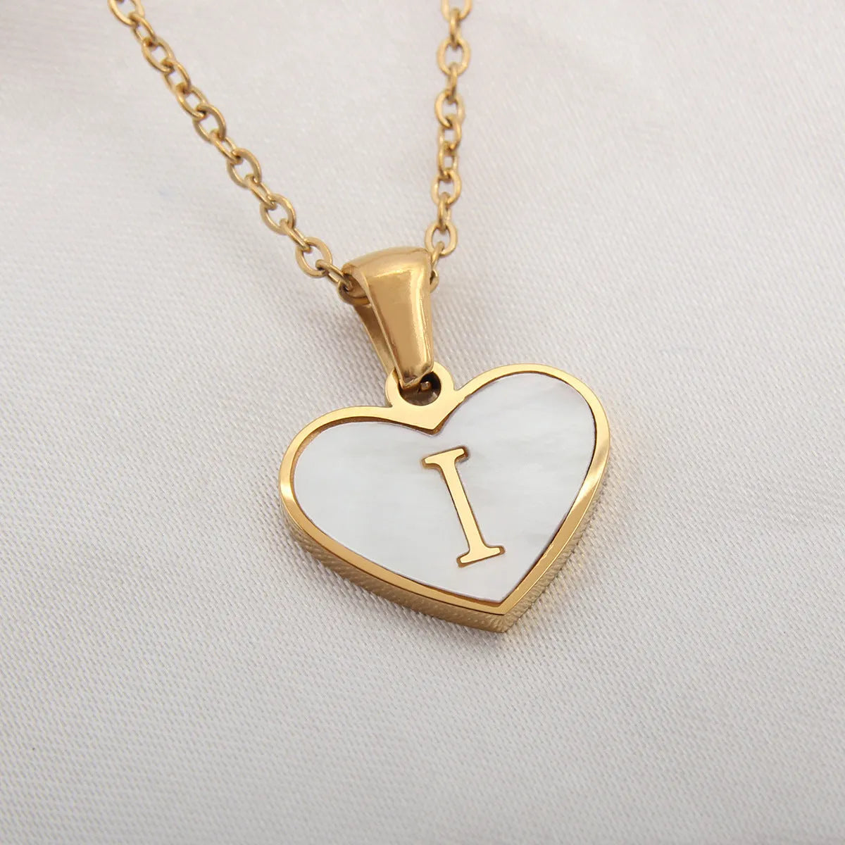 Gold plated heart necklace with white shell detail on an adjustable chain