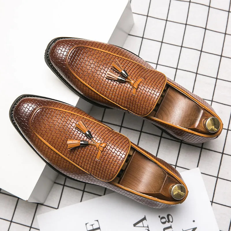 Men's black slip-on shoes with pointed toe and tassel decoration on artificial PU upper