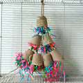 A wood-coloured parrot toy shaped like a paper cup with palm weaving texture, hanging from a string.