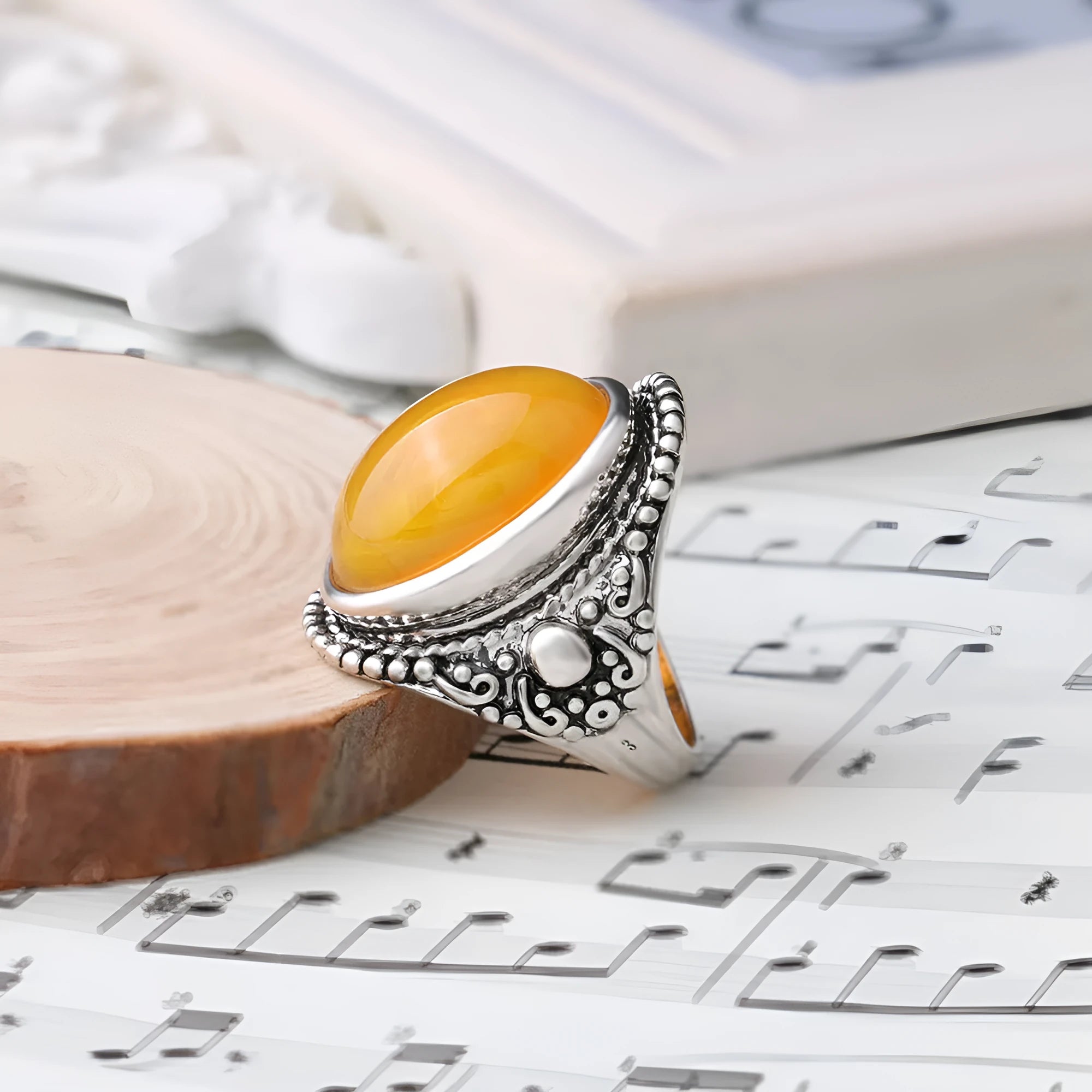Retro geometric alloy ring in antique silver amber colour on a grey background.