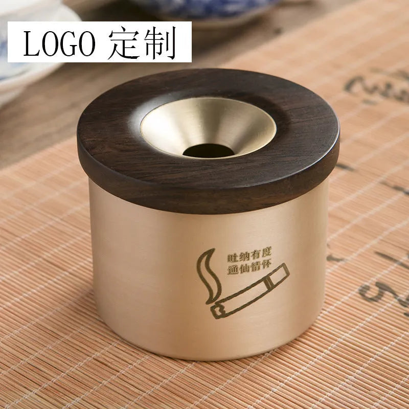 Retro brass ashtray with solid copper construction and hinged wooden lid featuring central circular aperture