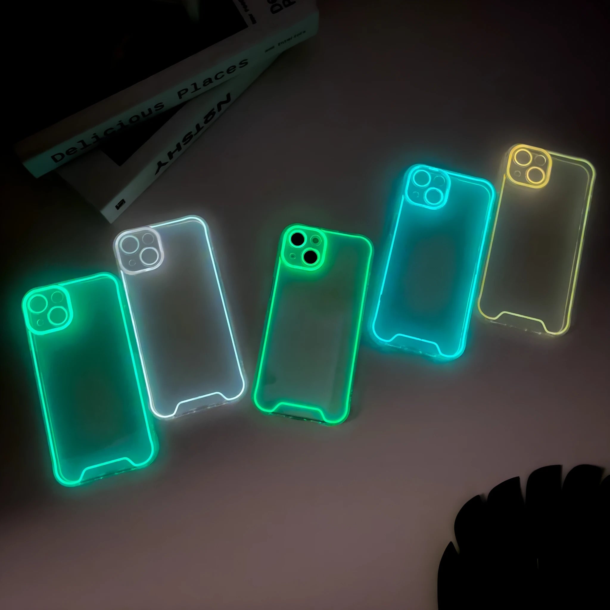 Glow in the dark Christmas soft shell phone case for iPhone in green, orange, blue, yellow, or pink.
