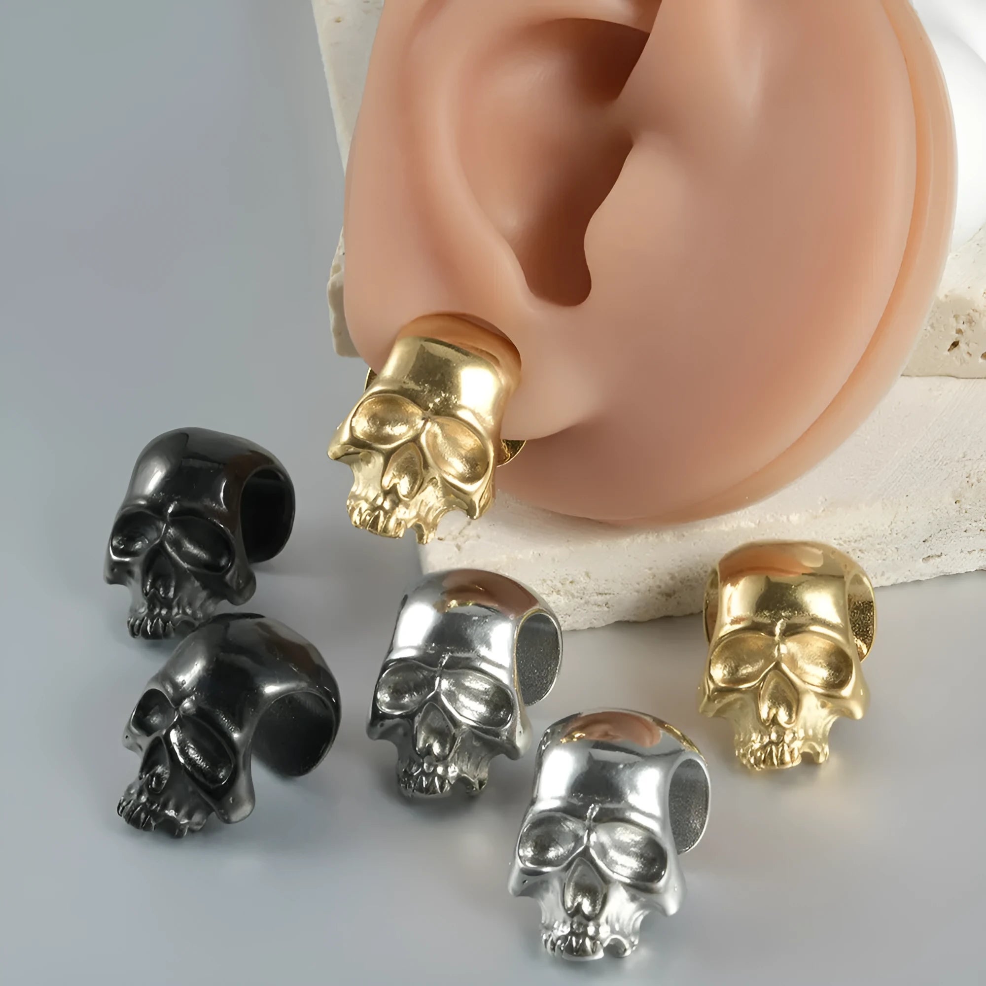 Stainless steel hollow skull Buddha earrings in geometric design with electroplated colour finish