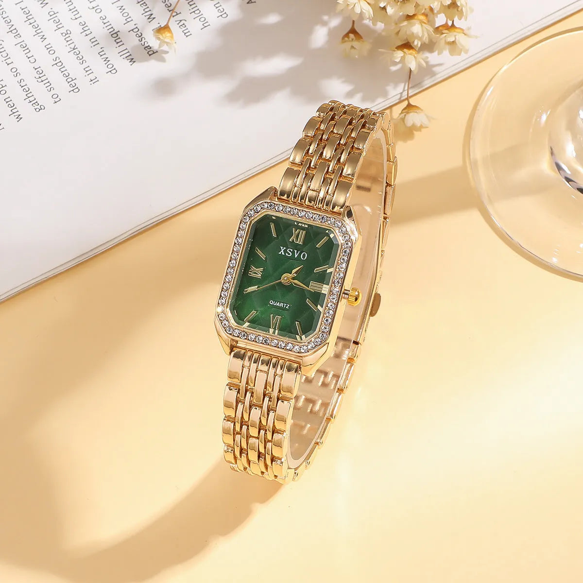 Gold green square women's watch and four matching butterfly bracelets from a five-piece fashion jewellery set.
