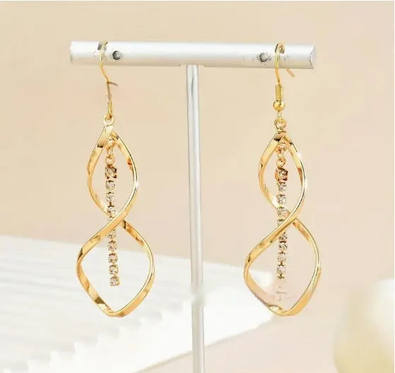 Gold geometric spiral design alloy earrings with elliptical shape