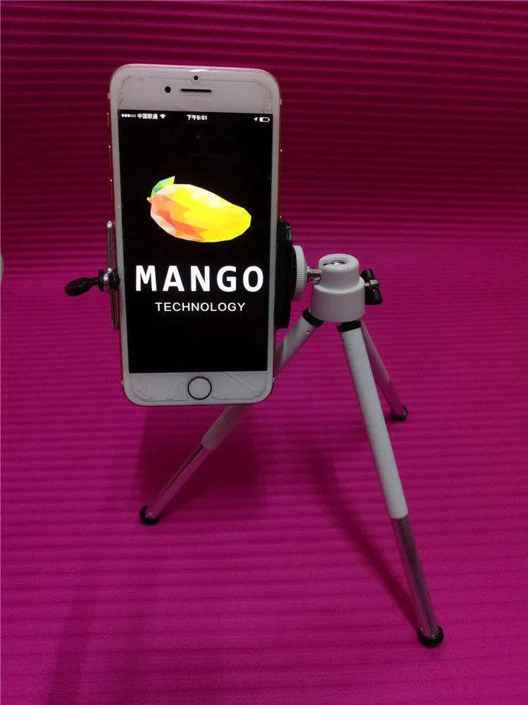 Black desktop phone holder with two-section metal bracket on a wooden desk.