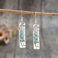 Long silver geometric earrings with turquoise inlay details on zinc alloy