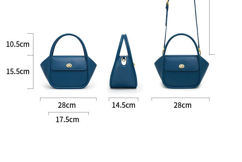 A wing-shaped cow leather tote bag with a buckle latch closure, shown in blue with a single cross-body strap.