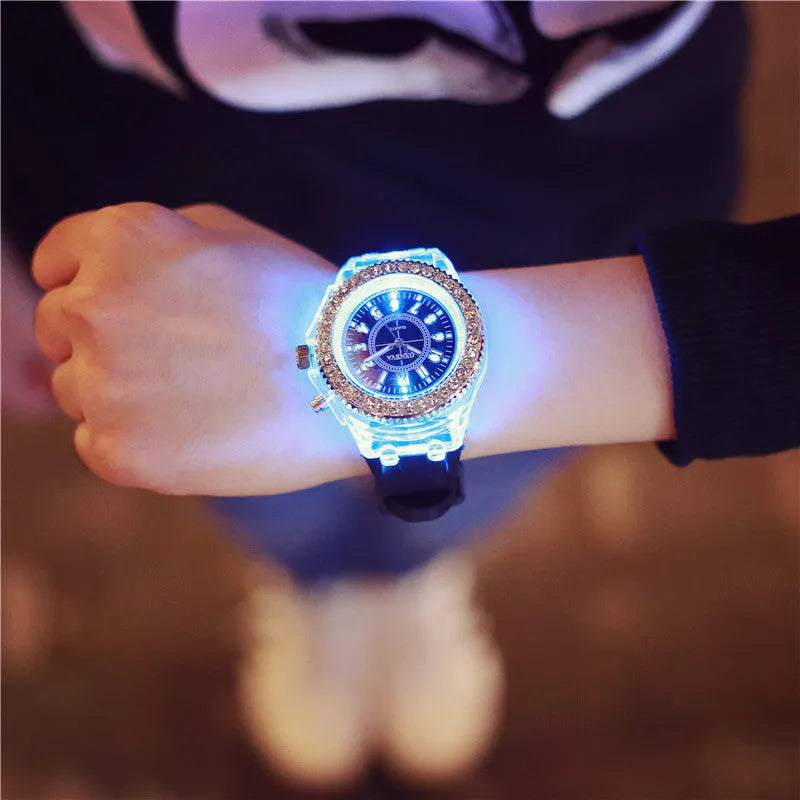 Women's LED luminous watch with round alloy case and colourful silicone strap.
