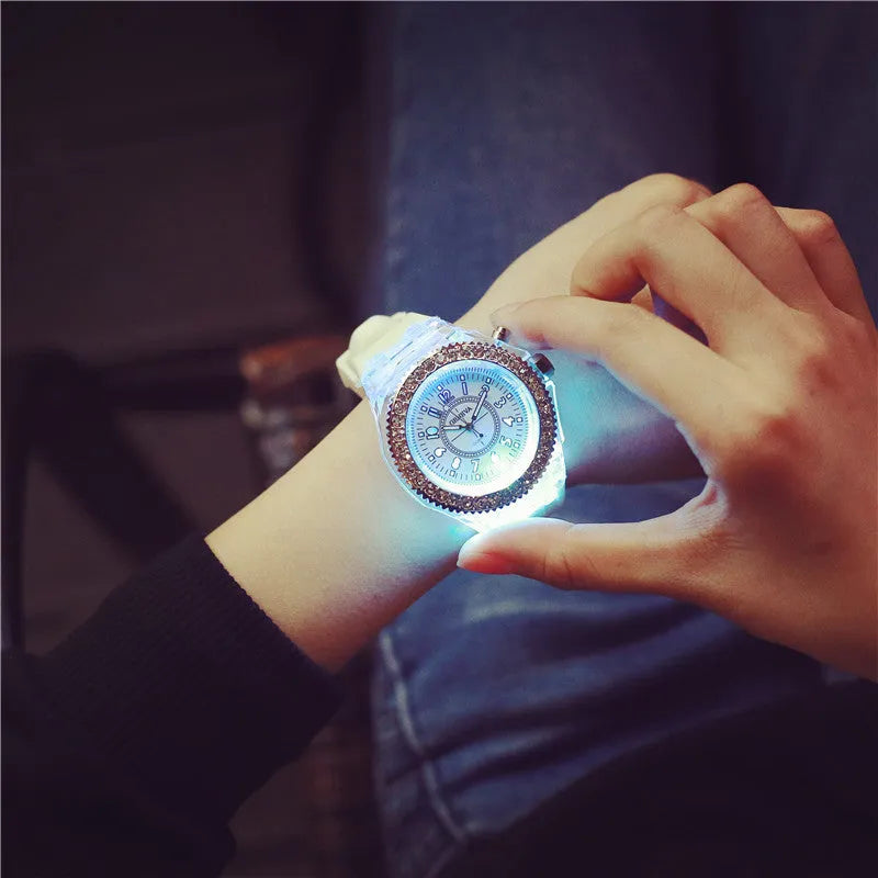 Women's LED luminous watch with round alloy case and colourful silicone strap.