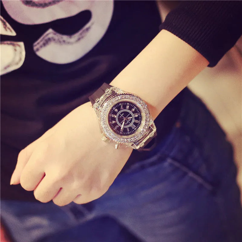 Women's LED luminous watch with round alloy case and colourful silicone strap.