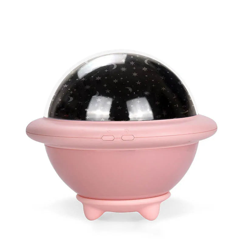 Green UFO-shaped plastic night light projecting starry sky pattern on a wall