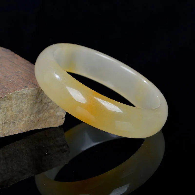 Natural light jade bracelet with polished surface in traditional Chinese style showing size options