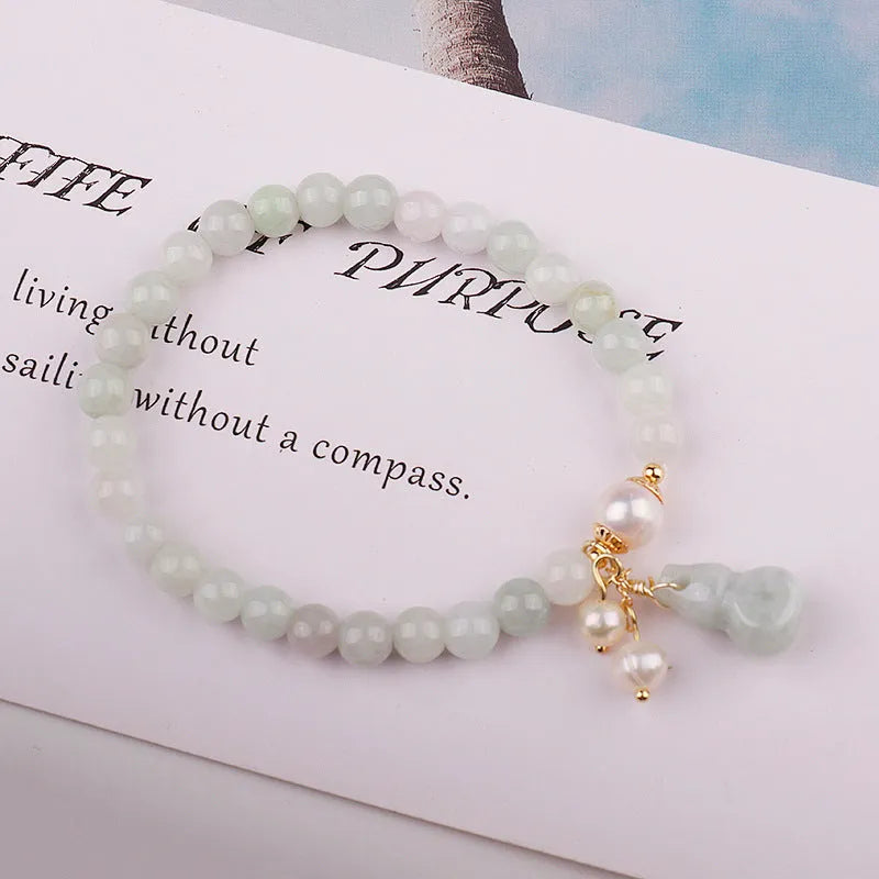 Chinese style jade bracelet with gourd design featuring natural emerald stone and pearl accents