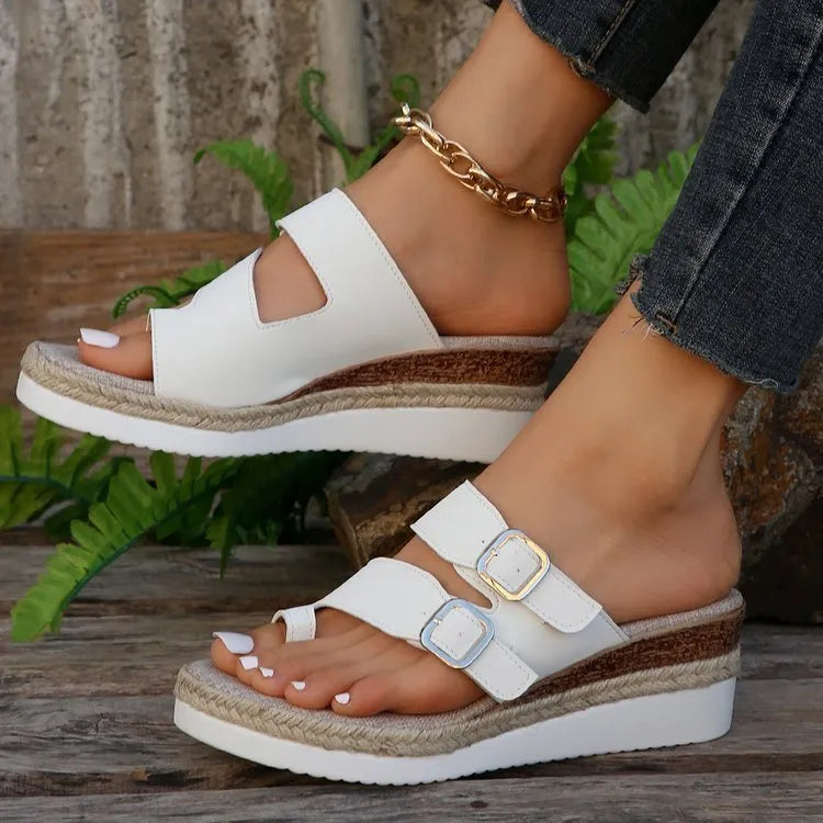 White women's woven patent leather wedge sandals with finger-fit design and peep toe.