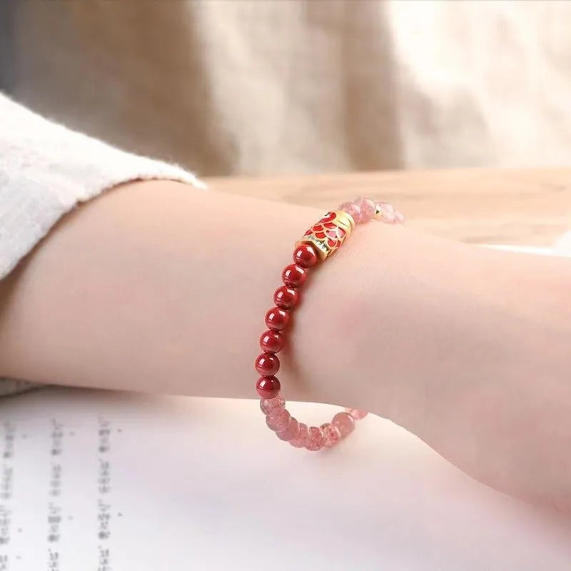 Women's retro bracelet with purple cinnabar and pink strawberry quartz beads on a wrist.