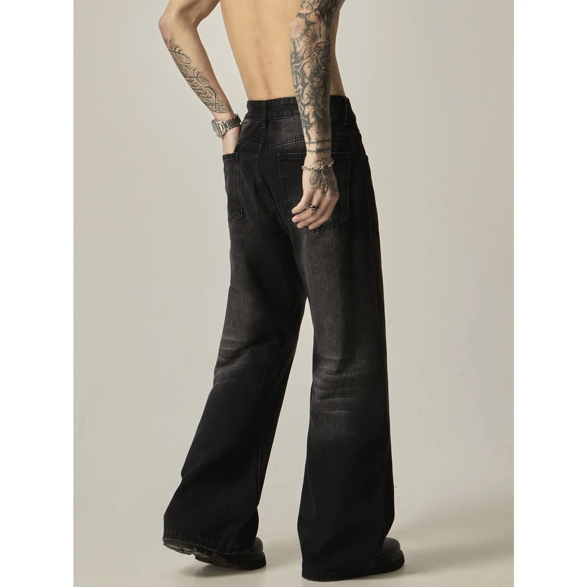 Black retro straight leg jeans with loose fit and zipper fly on hanger