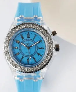Women's LED luminous watch with round alloy case and colourful silicone strap.