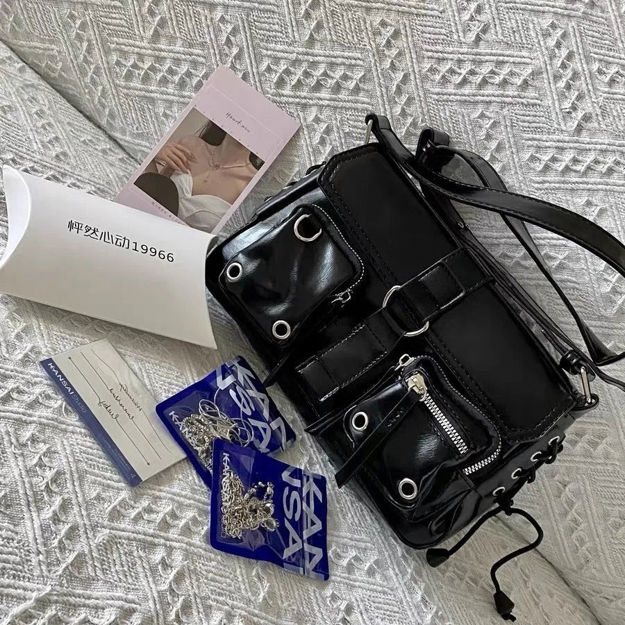 Black PU leather underarm baguette messenger bag with adjustable crossbody strap showing compact dimensions